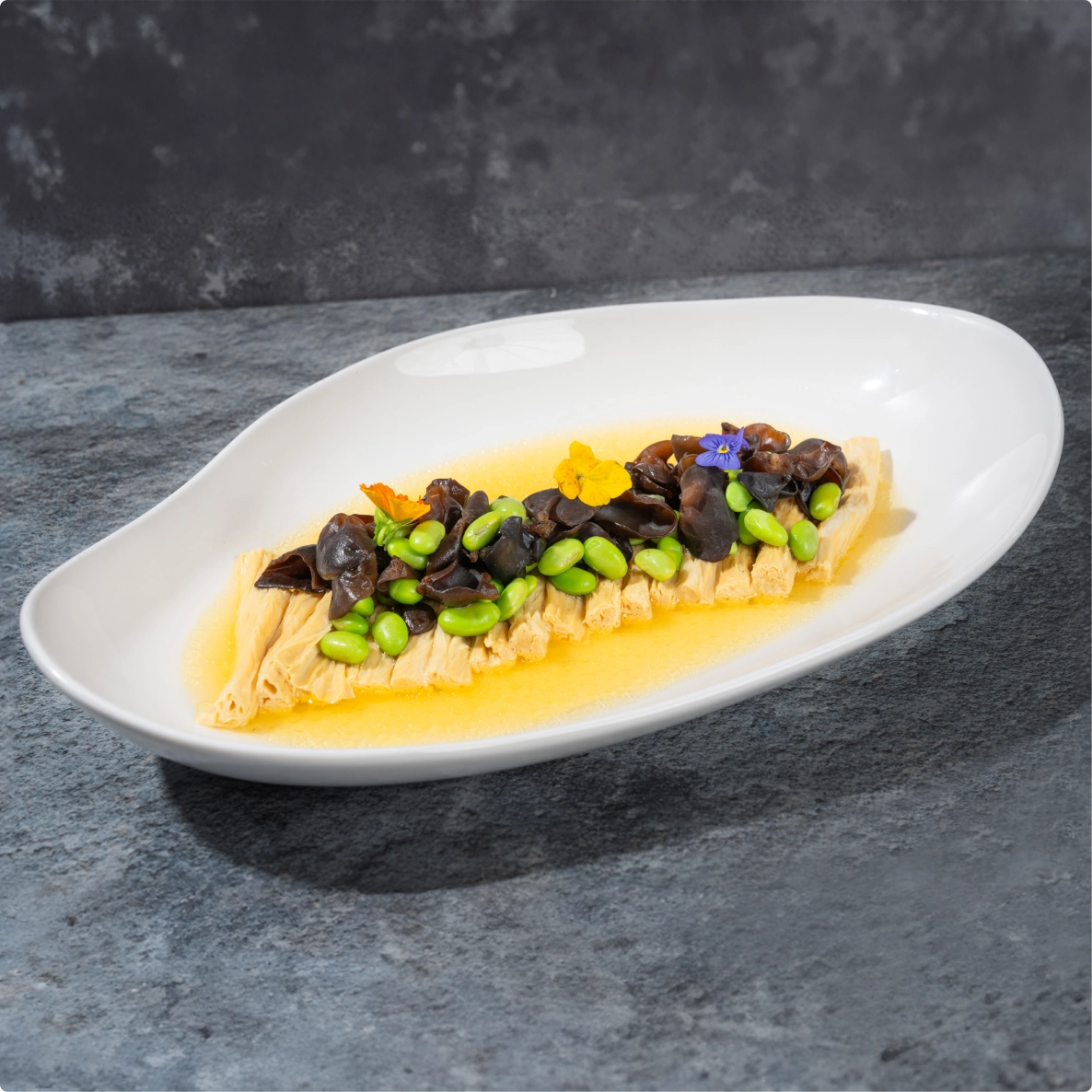 Zuming tofu rolls served with tender vegetables in a light, flavorful sauce